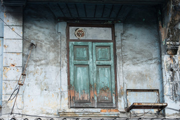 Old ancient wooden window with the original scenery of the old town, Chinatown, Thailand