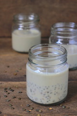 black sesame soy milk in glass on wood