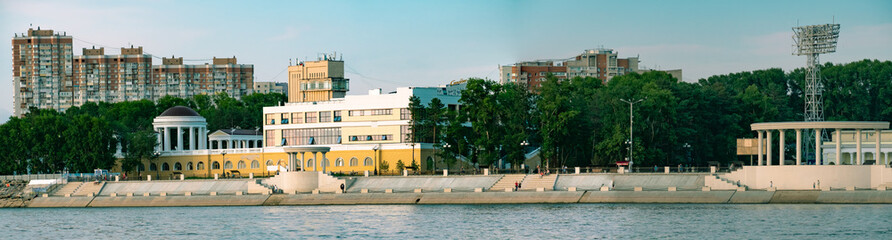 View of the city of Khabarovsk from the Amur river. Urban landscape in the evening at sunset. Large panorama of the city.