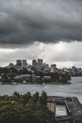 Obraz premium Pyrmont, New South Wales - JUNE 24th, 2019: Ominous clouds hang over Pirrama Park and Darling Island with Balmain East and North Sydney visible in the background.