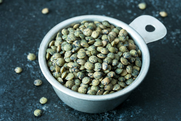 French Green Lentils in a Measuring Cup