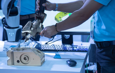 Industrial technician operating portable 3D measuring arm in manufacturing factory © Itsanan