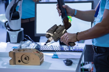 Industrial technician operate portable 3D measuring arm in manufacturing factory