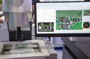 Vision measuring instrument inspecting a printed circuit board PCB board. Electronics industry