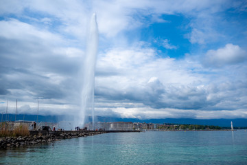 Beautiful panorama view of Geneva lake and Jet d'eau fountain on clouds sky background with copy space, Switzerland