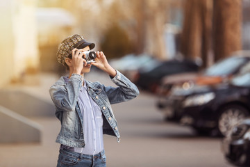 Fototapeta premium Young girl with photo camera outdoors