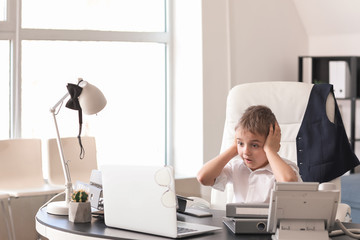 Worried little businessman in office