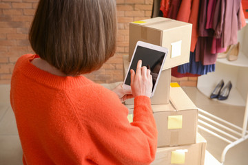 Female owner of online shopping site preparing order for client