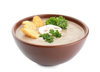 Bowl of tasty mushroom cream soup on white background