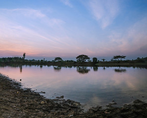 Lakes in the evening and reflections on the water of the sky and the trees with beautiful patterns and artistic colors