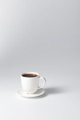 cup of coffee on bright gray background