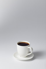 cup of coffee on bright gray background