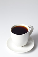 cup of coffee on bright gray background