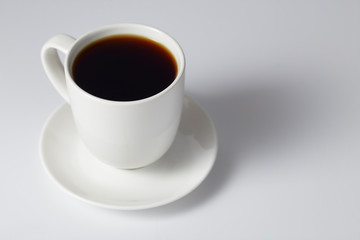 cup of coffee on bright gray background