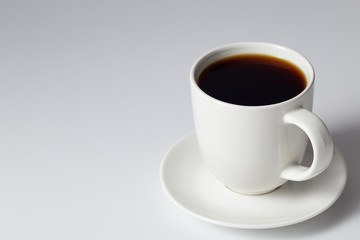 cup of coffee on bright gray background