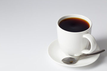 cup of coffee on bright gray background