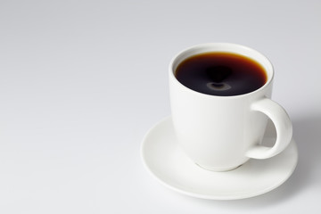 cup of coffee on bright gray background