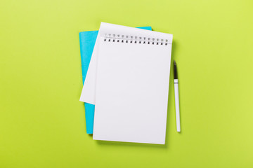school notebook on a green background, spiral notepad on a table.