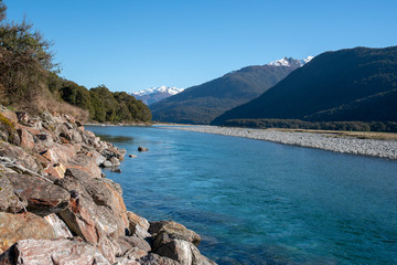 Fototapeta na wymiar clean pritine blue river water flowing through the Southern Alps