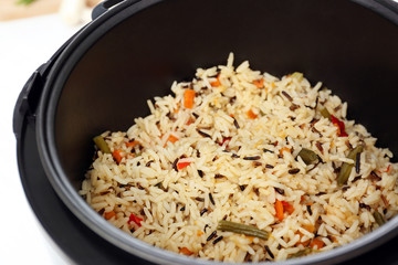 Prepared rice with vegetables in multi cooker, closeup