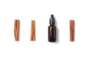 Flat lay composition with cinnamon essential oil on white background