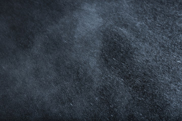 Rain drops falling down against dark background