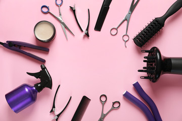 Frame made of scissors and other hairdresser's accessories on pink background, flat lay. Space for text