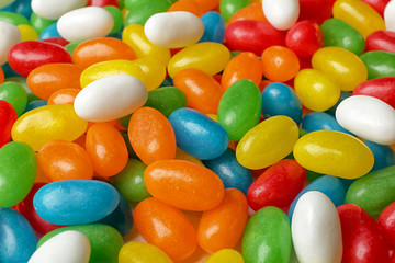 Tasty bright jelly beans as background, closeup