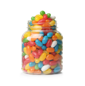 Glass jar of tasty bright jelly beans isolated on white