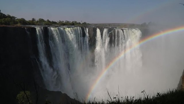 Magnificent Victoria Falls in Simbabwe with rainbox during dry season