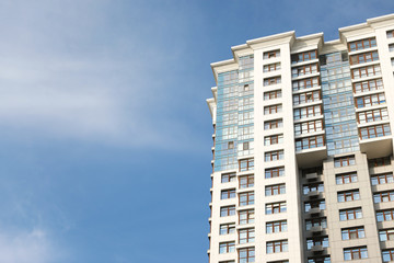 Fototapeta premium Modern building with tinted windows against sky. Urban architecture