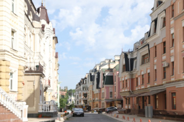 Fototapeta na wymiar Blurred view of buildings with beautiful windows in city