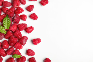 Composition with delicious ripe raspberries on white background, top view