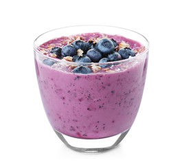 Glass of tasty blueberry smoothie with muesli on white background