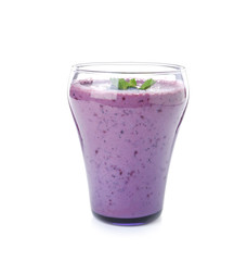 Glass of tasty blueberry smoothie with mint on white background
