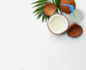 Composition with drink and coconuts on white background, top view