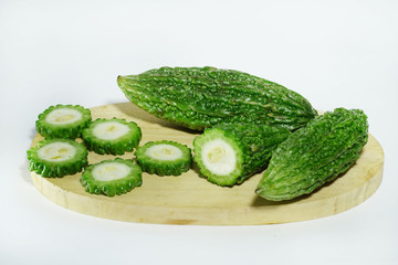 bitter melon on cutting board isolated on white background