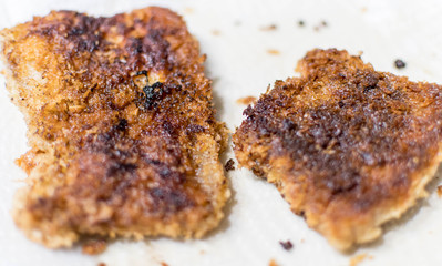 breaded pork chops on a plate toasted and golden brown color