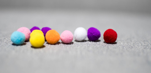 A colorful Pom Pom balls background with gray space