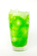 Summer drink; green soda on ice in glass isolated on white background