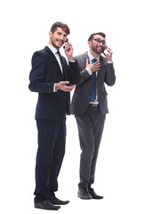 full length . two businessmen using their smartphones