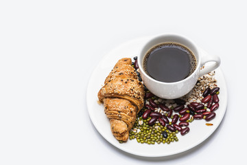 Croissant  with cereal and coffee isolated