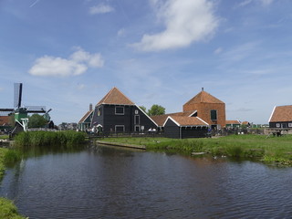 Fototapeta na wymiar Windmills by the water. Authentic town. The old town in Holland.