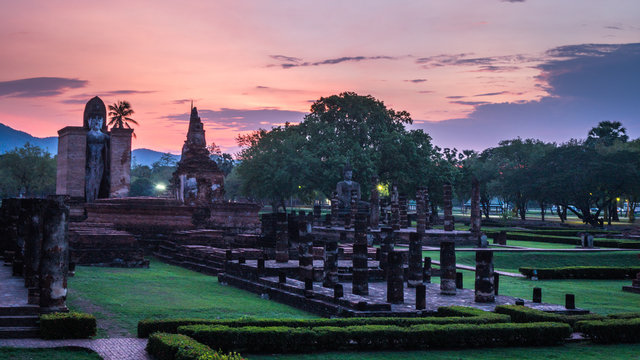 Wat Mahathat Temple at the Historical Park in Sukhothai at sunset with colorful sky