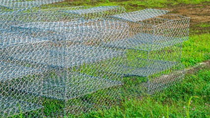 Empty gabion (wire basket) ready to be used in construction working site. Gabion is used for erosion control