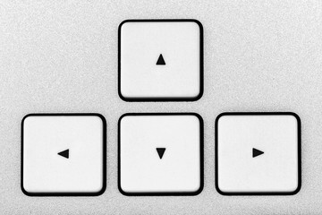 White aluminum arrow button close-up keyboard