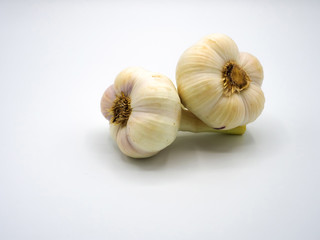 two tuber garlic separated on white background