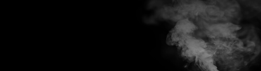 White smoke on a black background. Texture of smoke. Clubs of white smoke on a dark background for an overlay