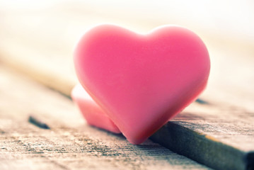 Vintage pink hearts lay on wood table for love concept.
