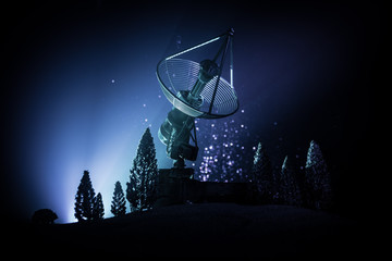 Silhouettes of satellite dishes or radio antennas against night sky. Space observatory.